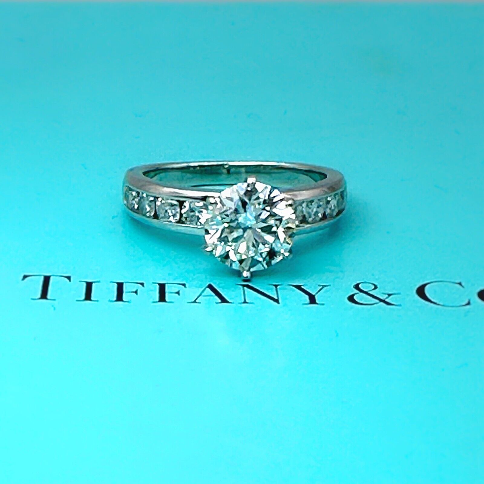 Tiffany Setting Channel Set Solitaire Engagement Ring Hotel